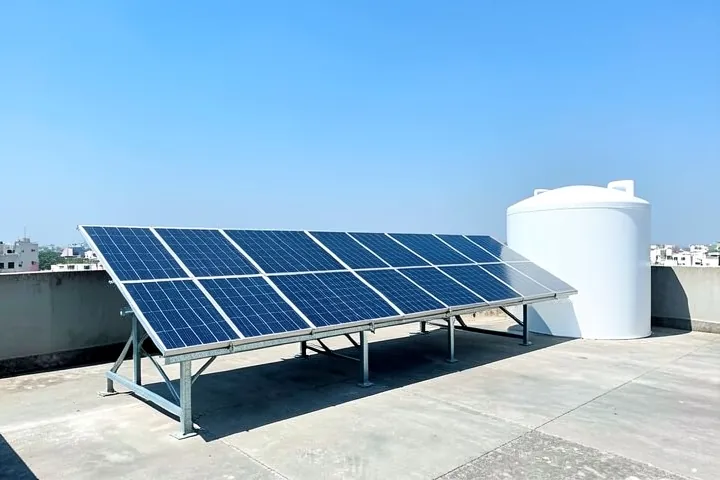 Six solar panels in a single row on a city house terrace